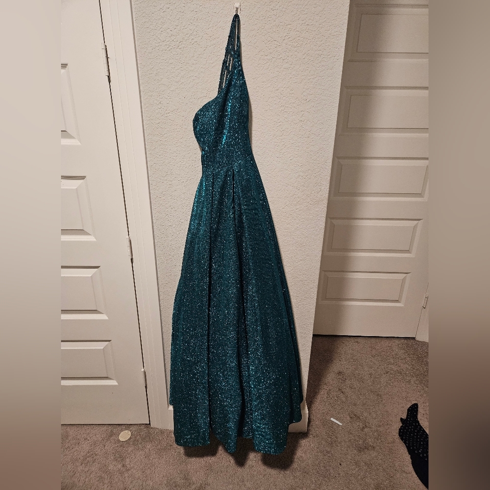 A long one sholder dress with pockets and sparkles and laced back